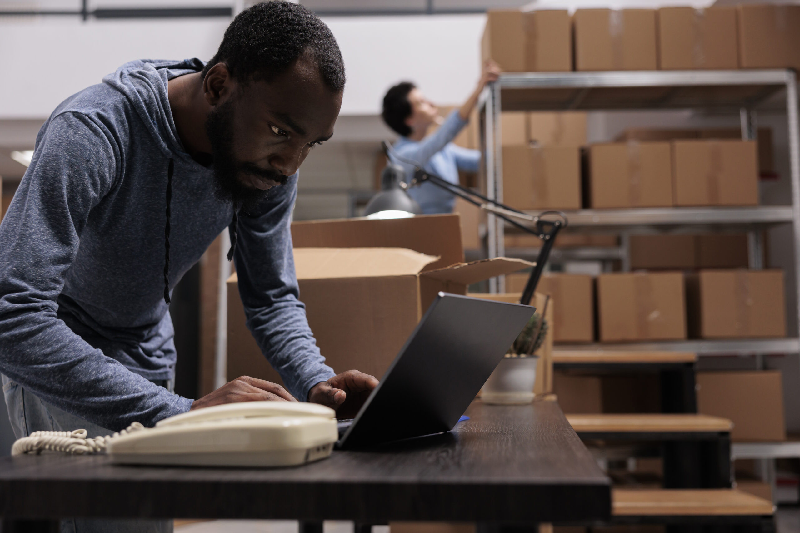 african american employee looking at cargo stock before start preparing customers orders