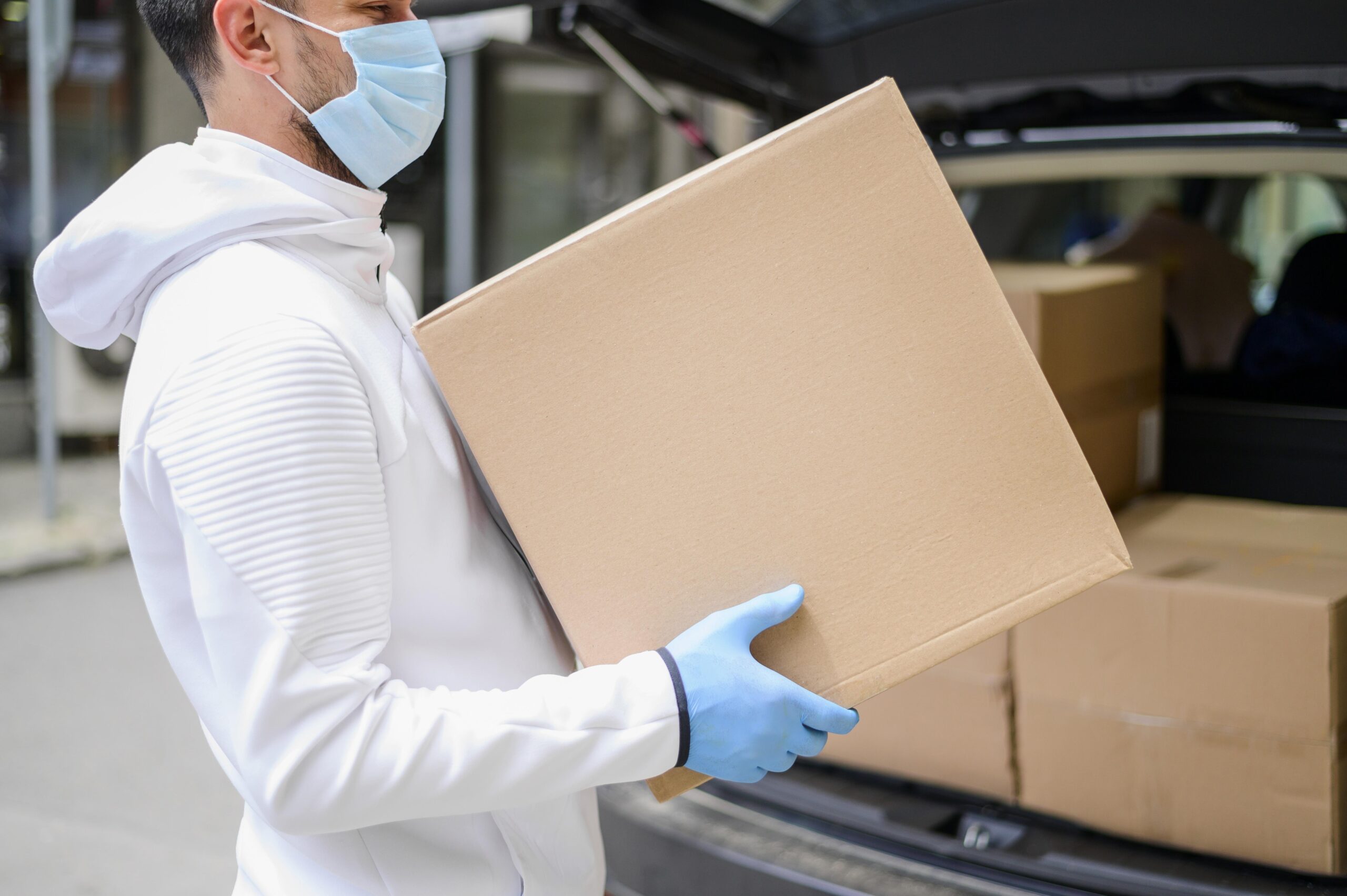 delivery guy carrying cardboard box